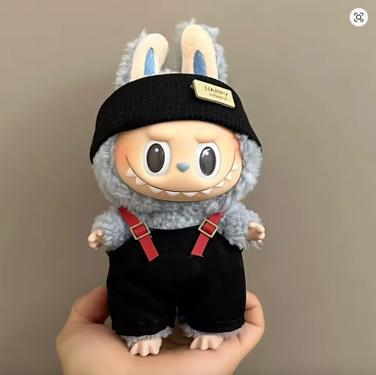 labubu figure with black headband, and suspenders 